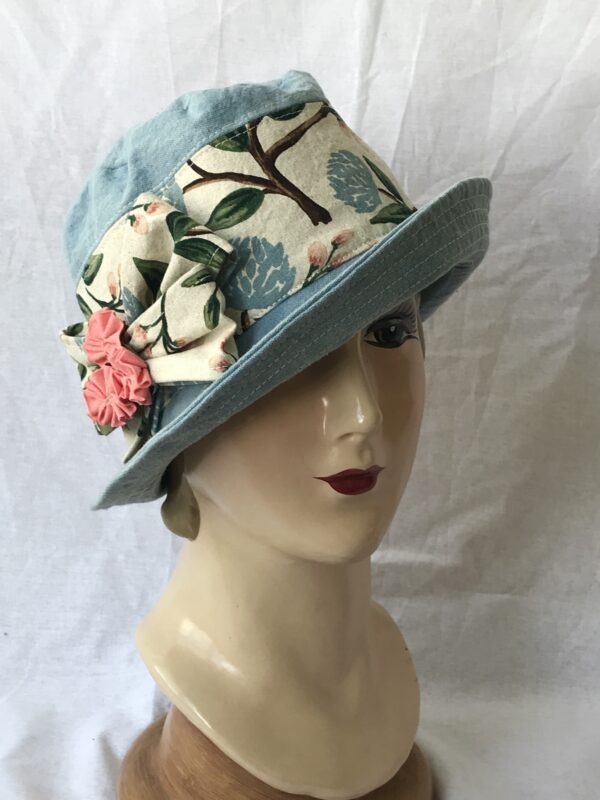 1940s inspired sky blue cotton canvas fedora with floral print, double bow and handmade fabric flowers. Dapper yet feminine.