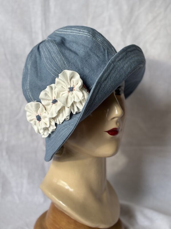 sky blue cotton canvas cloche hat with 3 white fabric pansy flowers.