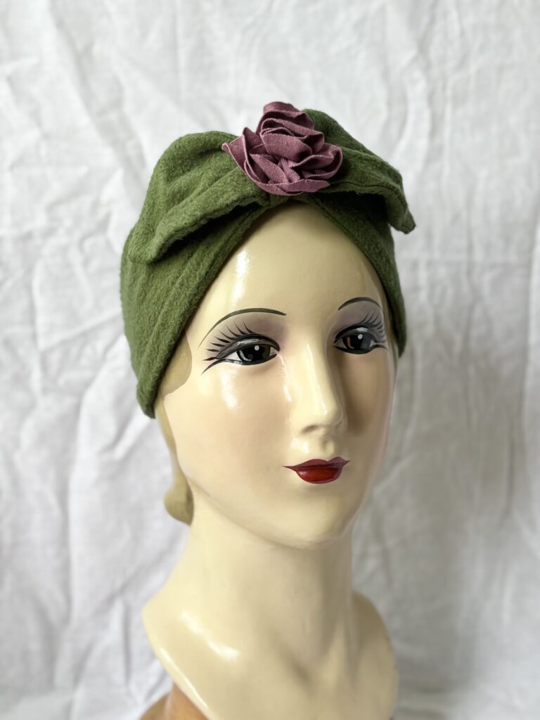 Tencell fleece turban headband in moss green with purple rose.
